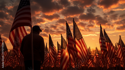 Silhouetted against the fading light, American flags pay tribute to those who served their country.