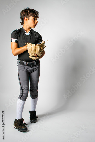 Youth baseball player pitcher starting his wind up to pitch the ball photo