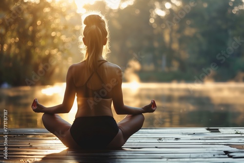 Young, beautiful woman meditates in a lotus position, seeking inner peace and tranquility.