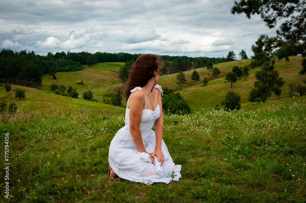 Beautiful girl at nature valley outdoor. Freedom lifestyle. Carpathians mountain girl. Woman in windy valley. Woman in the mountain valley. Landscape of summer nature. Picturesque view Beautiful girl at nature valley outdoor. Freedom lifestyle. Carpathians mountain girl. Woman in windy valley. Woman in the mountain valley. Landscape of summer nature. Picturesque view