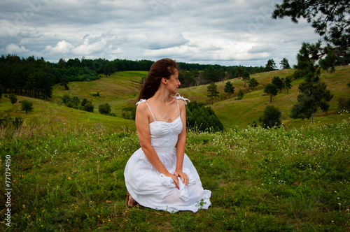 Landscape of summer nature. Beautiful girl at nature valley outdoor. Freedom lifestyle. Carpathians mountain girl. Woman in windy valley. Woman in the mountain valley. Quaint villages