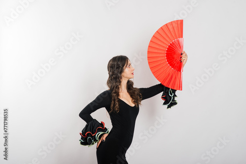 Portrait of beautiful young woman dancing flamenco in studio