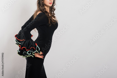 Portrait of beautiful young woman dancing flamenco in studio