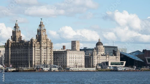 Timelapse of the Liver Building, Cunard Building and the Port of Liverpool Building known as the Three Graces with clouds moving and the Mersey ferry dropping passengers off photo