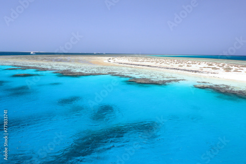 Captivating view of Egypt's Red Sea coral reef near Marsa Alam, Hamata Islands. Crystal-clear turquoise waters under a warm, sunny sky.