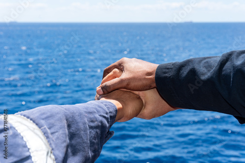 Konstfotografi Close up top view of young seafarers putting their hands together