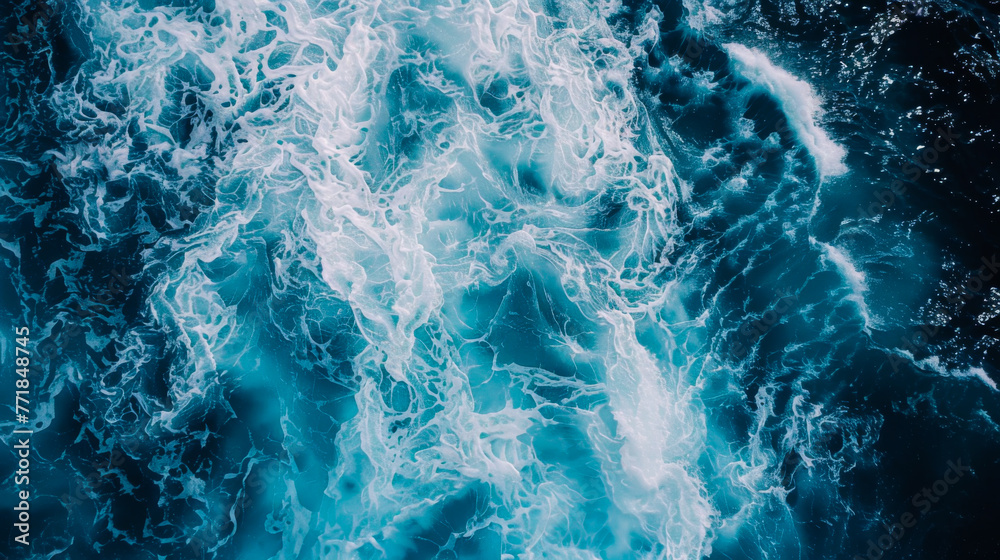 Naklejka premium Coast with waves as a background from top view. Blue water background from drone. Summer seascape from air