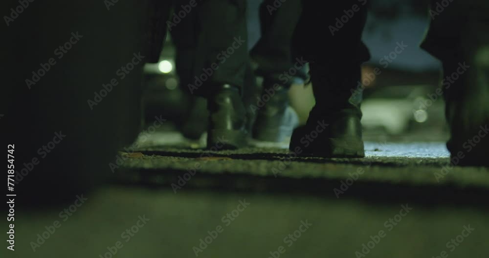 Swat, military, or black military boots moving in coordination. Preparing for raid. Walking on concrete, Low angle of feet. High intensity movement. concrete, Low angle of feet. Night Time