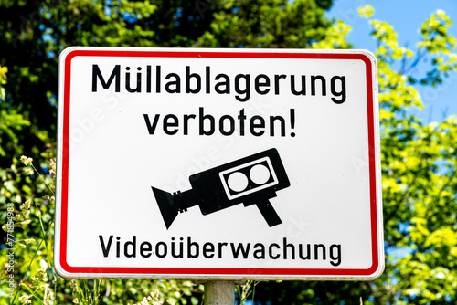 Sign prohibiting waste disposal and information about video surveillance in Austria