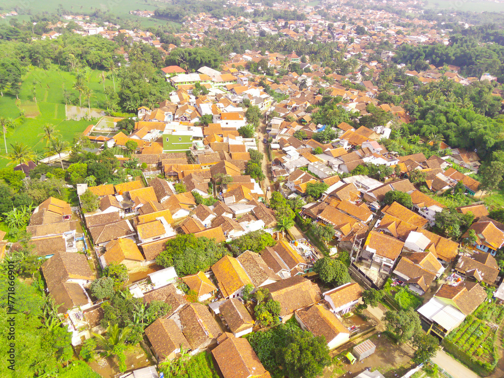 Fototapeta premium Cityscape of downtown district in Bandung city, Indonesia. View of the dense residential and highways in Downton. Social Issues. Drone Photography. Shot from a drone flying 100 meters