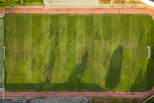 Aerial view of athletes playing soccer match on a grass field in Brazil photo