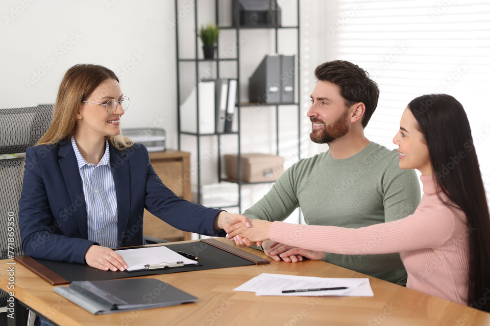 Lawyer shaking hands with clients in office Lawyer shaking hands with clients in office