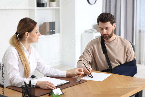 Injured woman having meeting with lawyer in office