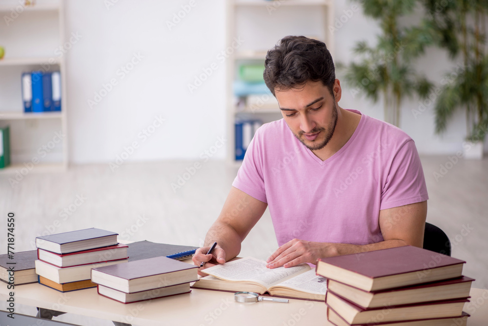 Young male student sitting in the classroom Young male student sitting in the classroom