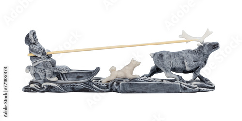 Figurine of a musher on a reindeer team with a dog