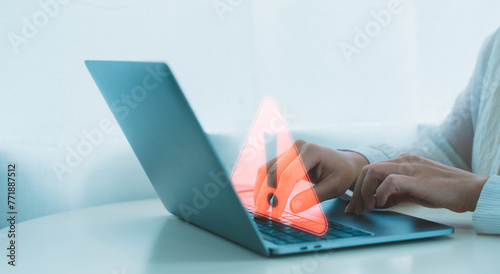 Cuadro en lienzo Businessman or programmer, developer using computer laptop with triangle caution warning sign for notification error and maintenance concept