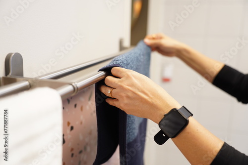 Woman drying towels on a rack