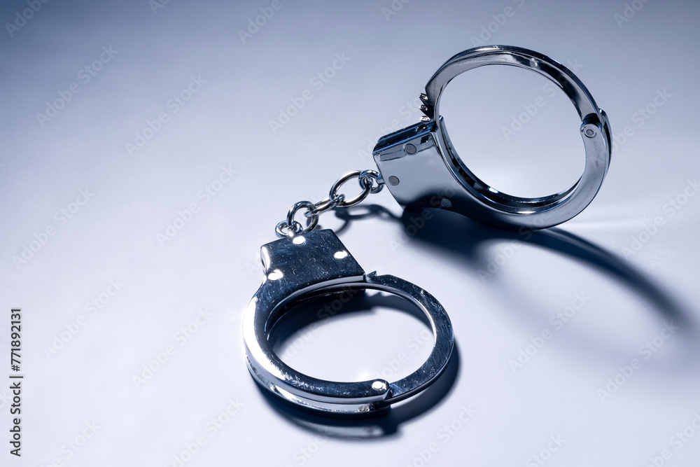 close up handcuffs on dark background. close up handcuffs on dark background.