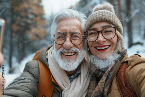 Wonderful sincere and cheerful pair of white-haired mature smiling people selfie on their mobile phones. Enjoy life. Pay attention to the health of the elderly 