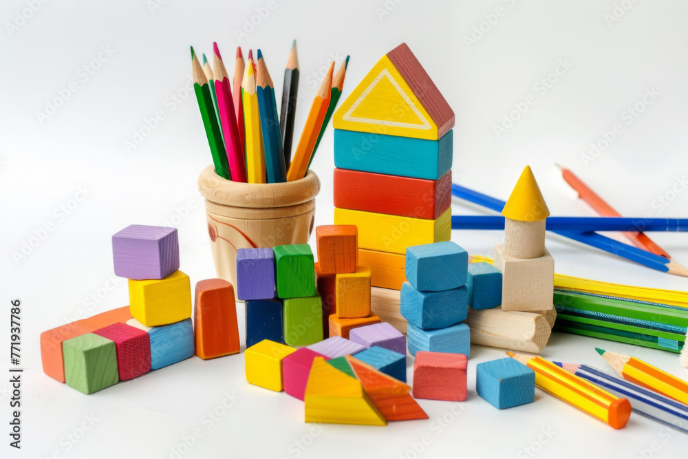 Fototapeta premium Colorful back-to-school wooden toy blocks accompanied by a group of school supplies on a white background