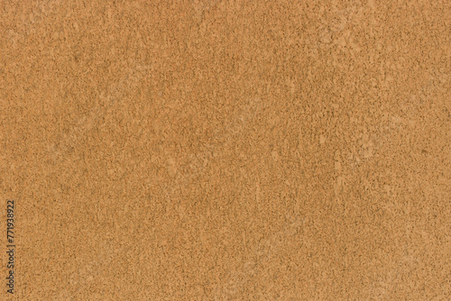 Brown sand color rough wall plaster solid surface texture background stucco backdrop pattern