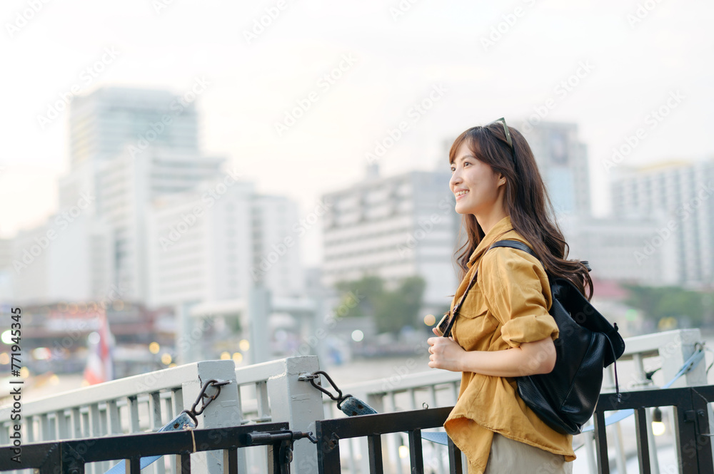 Fototapeta premium young Asian woman in 30s on a solo adventure. captures the essence of cultural exploration and joyful discovery.