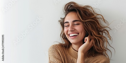 Joyful woman with phone against a white wall, smiling, Generative AI 