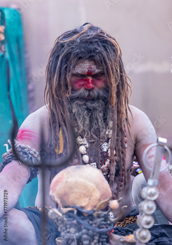 Portrait of an naga aghori sadhu holy man with pyre ash on his face and body performing aghor sadhna at harishchandra ghat in varanasi.