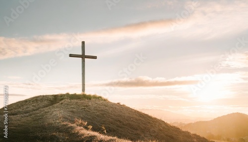 cross on a hill with a sunset easter background with copy space for text