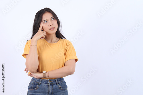 Beautiful young Asian girl thinking and looking upwards. The concept of content thinks about future isolated on white background.