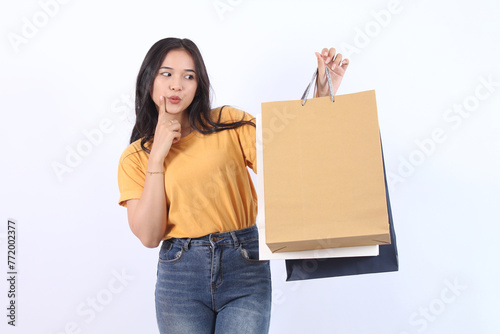 Asian happy female woman girl holds colourful shopping packages standing on white background studio shot, Close up Portrait young beautiful attractive girl smiling looking at camera with bags