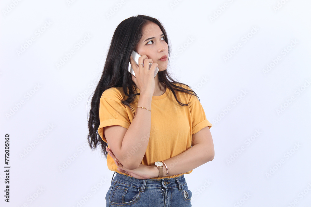 Friendly smiling asian woman talking on phone, girl on call, holding smartphone and laughing, speaking, standing over white background Friendly smiling asian woman talking on phone, girl on call, holding smartphone and laughing, speaking, standing over white background