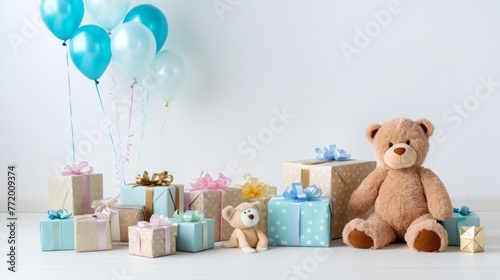 A white background with a blue and pink balloon and a teddy bear