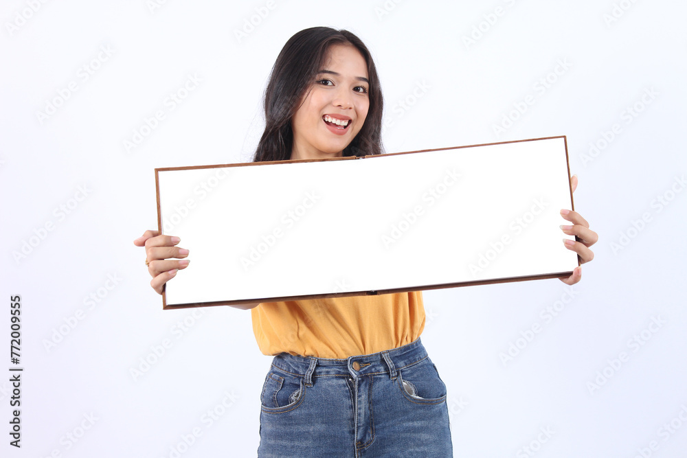 Beautiful young Asian woman on yellow t-shirt holding presentation book on white background. book mock up presentation Beautiful young Asian woman on yellow t-shirt holding presentation book on white background. book mock up presentation