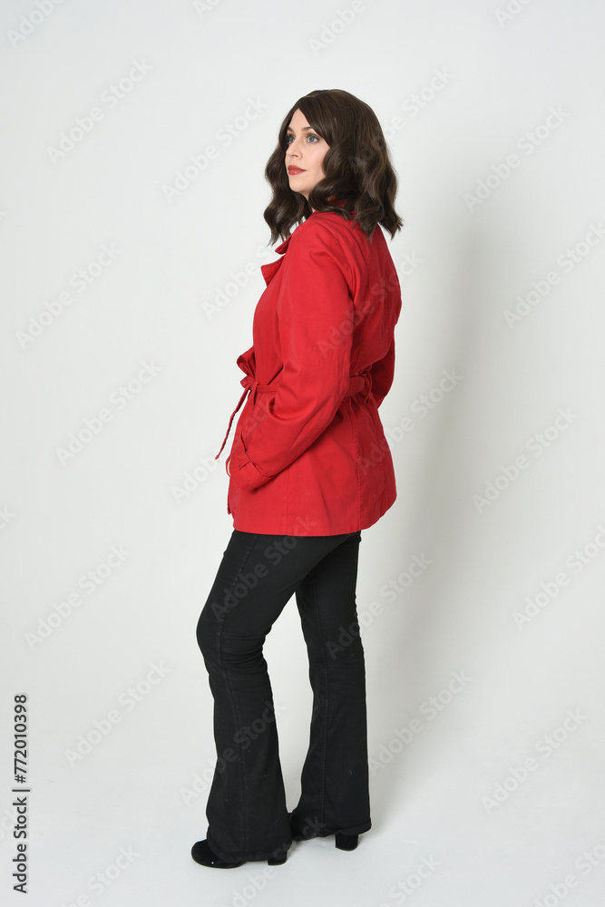full length portrait of beautiful brunette woman model, wearing red trench coat jacket leather pants. standing pose in backview, walking away the camera. isolated silhouette on white studio background full length portrait of beautiful brunette woman model, wearing red trench coat jacket leather pants. standing pose in backview, walking away the camera. isolated silhouette on white studio background