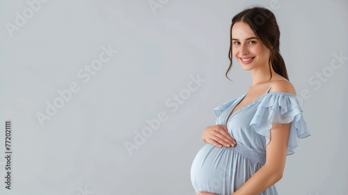 Caucasian pregnant woman with pregnancy belly, in soft blue clothes © pariketan