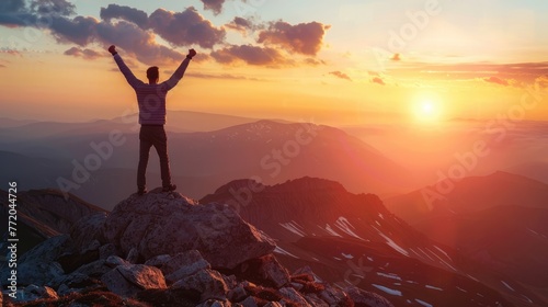 Positive man celebrating on mountain top