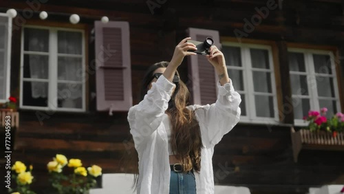 We were shooting on the phone. The girl is filming on a cell phone with a lens. The detachable lens on the phone. Traveling. A young brunette girl traveling and taking photos on the phone. High