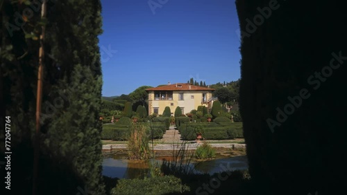 Homestead. Italian manor. Florence. Italy. Villa. Yellow house. Topiaries. Patio. Summer. Park. Italian style. Landscape design. Green yard. Country house. Vacation. Family house. High quality 4k