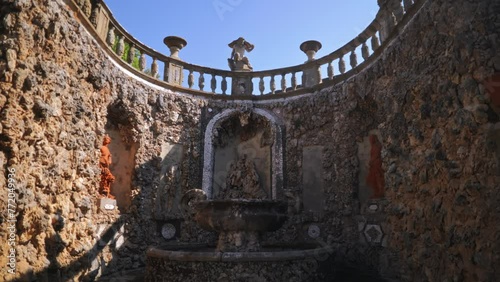 A little fountain. An old stone monument. An ancient fountain. Homestead with a fountain. Old architecture. Stone fountain. sculpture. Water. Stone. Molding. Monument. Garden. Home. Italian sculptures