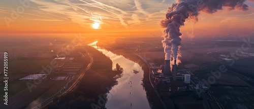 photo of a nuclear power plant in Germany, aerial view at sunset, a river flowing nearby, white plumes of smoke rising from the chimney ,, high-definition, 32K HD