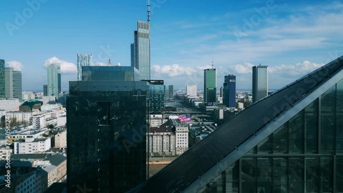 Skyscraper. Workday. Glass offices. Glass building. A house made of glass. High-rise. Roof. City. Multi-story buildings. High-rises. Megopolis. City center. Warsaw. Warsaw from the sky. Poland. Glass