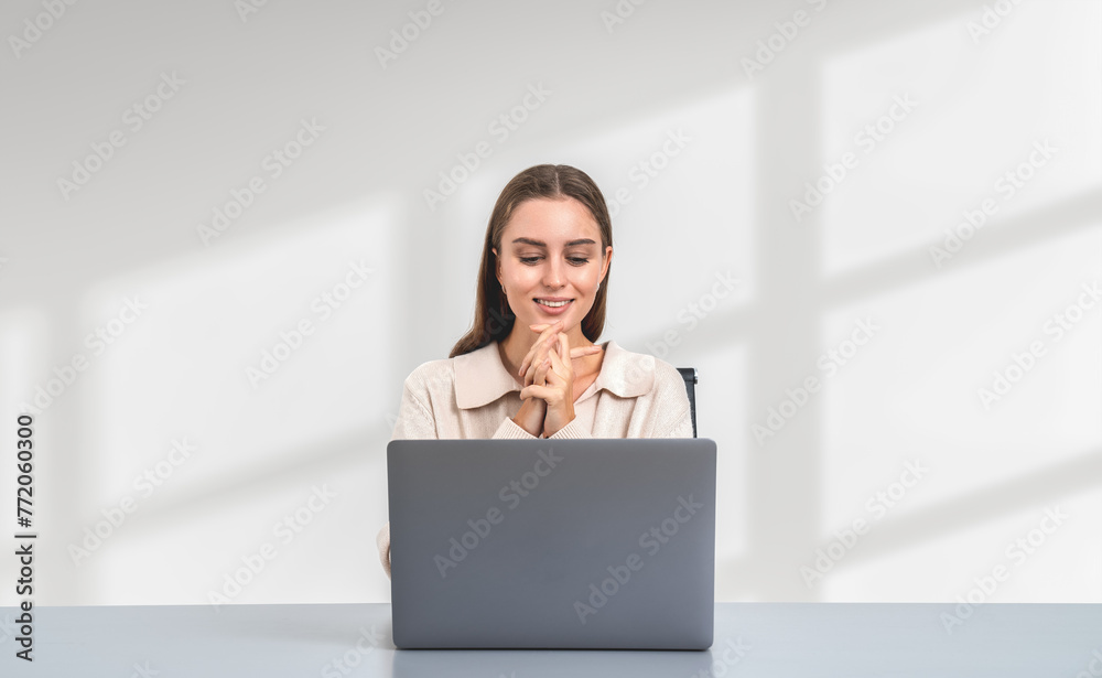 Businesswoman with laptop on table, smiling on copy space empty background Businesswoman with laptop on table, smiling on copy space empty background
