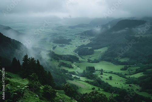 : A breathtaking view of a green valley from a hilltop