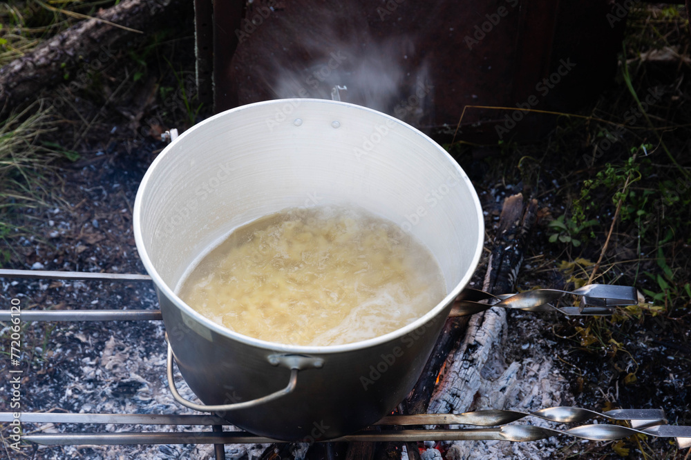 Cooking on a camping trip in an open fire pot. Cooking on a camping trip in an open fire pot.