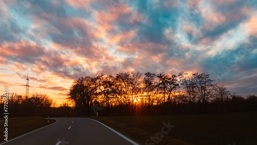 Fototapeta Naklejka Na Ścianę i Meble -  Sunset with a dramatic sky and overland high voltage lines near Tabertshausen, Deggendorf, Bavaria, Germany