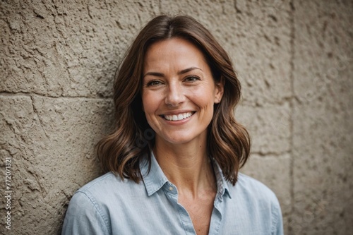 Portrait of smiling woman against a wall