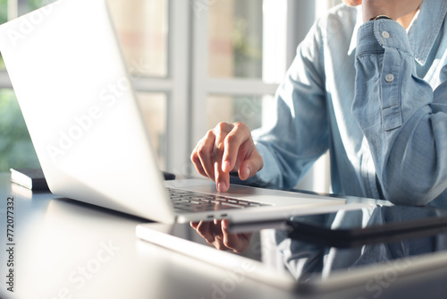 Young asian business woman thinking about problem solving at work. Casual businesswoman searching the information, working on laptop computer with digital tablet on office table