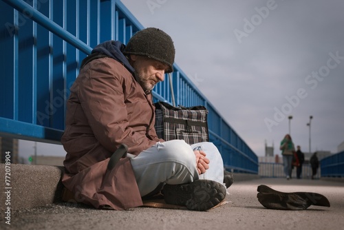 Senior citizen beggar on city overpass begging for some money