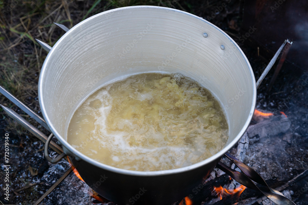 Cooking on a camping trip in an open fire pot. Cooking on a camping trip in an open fire pot.